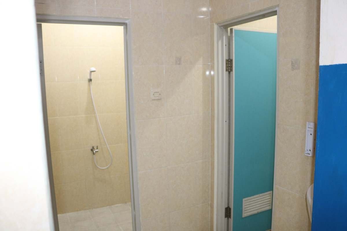 Kamar mandi murid dengan pintu biru